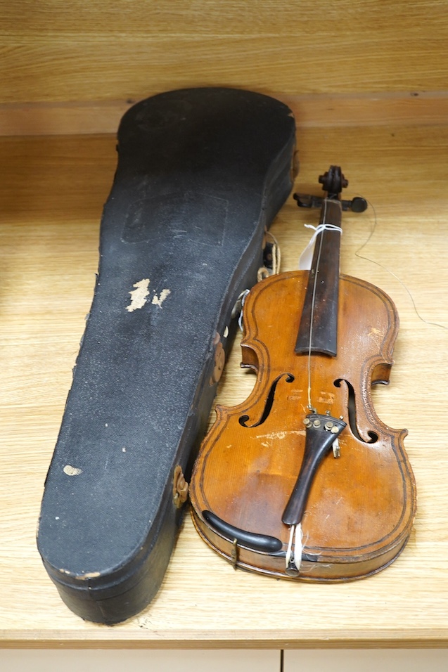 Two late 19th or early 20th century violins, one with case, back of largest measures 36cm. Condition - poor to fair